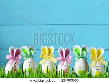 Easter Funny Bunny On Green Grass And Easter Eggs. Easter Background