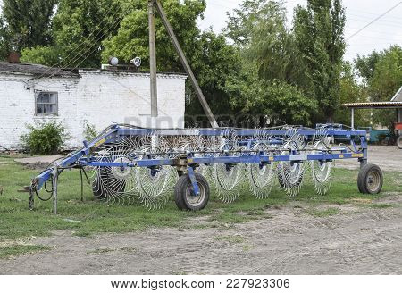 Tedder On Trailer For Tractor. The Machine For Gathering Hay.