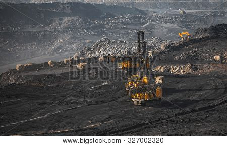 Open Coal Mine. Drilling Machine Borer Installing Cast Explosives Blasting