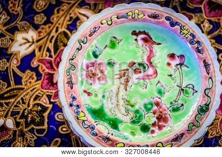 Colourful Peranakan Small Dishes On A Colourful Batik Table Cloth With Typical Peranakan Cookies