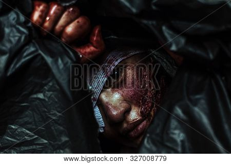 Horror Scence Of Face Woman In A Black Trash Bag At Abandoned House. Halloween Concept
