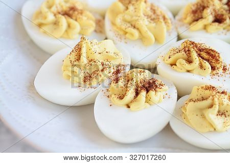 Plate Of Delicious Deviled Eggs Appetizers Sprinkled With Paprika For Easter. Selective Focus On Cen