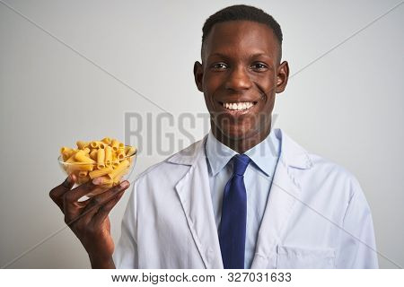 African american doctor man holding bowl with macaroni pasta over isolated white background with a happy face standing and smiling with a confident smile showing teeth