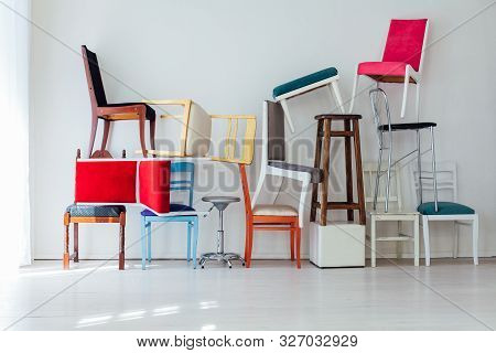 Lots Of Different Chairs In The Interior Of The White Room