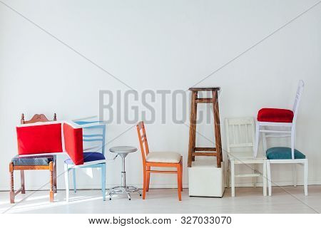 Lots Of Different Chairs In The Interior Of The White Room