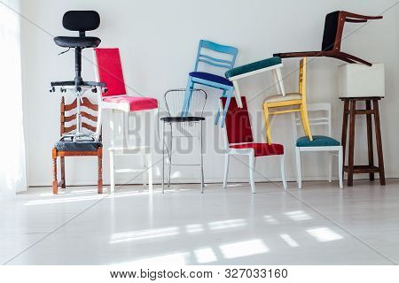 Lots Of Different Chairs In The Interior Of The White Room