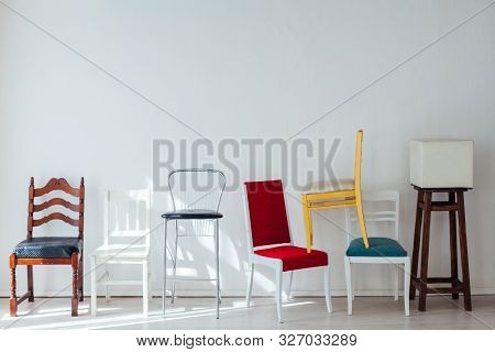Lots Of Different Chairs In The Interior Of The White Room