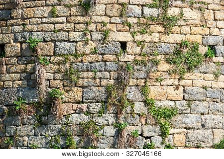 Fragment Of A Wall Of A Medieval Tower. The Wall Is Made Of Stones Of Various Shapes And Colors. On 
