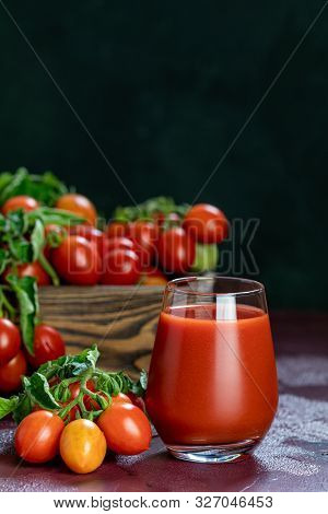 Glass Of Fresh Delicious Jummy Red Tomato Juice And Fresh Tomatoes In Wooden Box. Dark Background. C