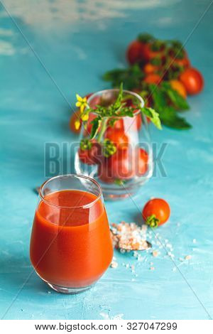 Glasses Of Fresh Delicious Jummy Red Tomato Juice And Fresh Raw Tomatoes With Pink Salt In Spoon On