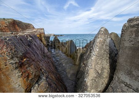 Seascape. A Stone Path Between Huge Concrete Blocks Of Bolata Beach. Northern Black Sea Coast, Bulga
