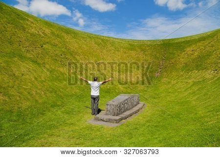 Man with open arms at the the Irish Sky Garden Crater, Skibbereen, West Cork. Ireland
