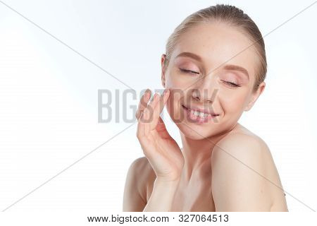 Portrait Of Beautiful Woman With Natural Make Up Touching Her Face.