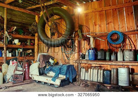 An Old Wooden Shed On A Remote Cordon, With A Tool For Repairing Equipment, With A Group Of Old Cani