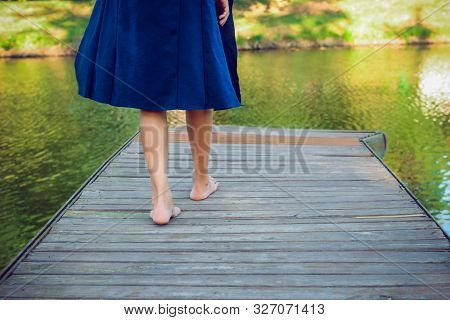 Young Woman Making A Step Bootlessly On The Wooden Pier And Moving Forward To The Water, New Opportu