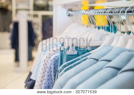 Close Up Blue Color Clothes On Hangers In Shop, Butique. Make Outfit Set. Shopping Mall. Shopper. Sa