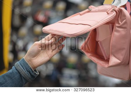 Student Girl Choosing A New Backpack In A Store.