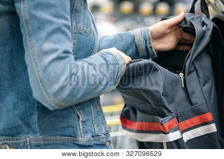 Student Girl Choosing A New Backpack In A Store.