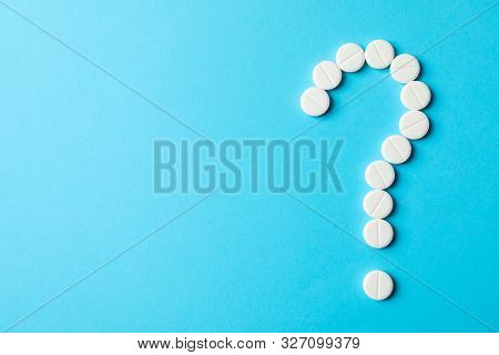 Question Mark Layd Out Of Pills On Blue Background, Space For Text