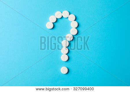 Question Mark Layd Out Of Pills On Blue Background, Space For Text