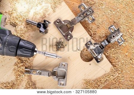 Installation Of Furniture Hinges In Chipboard. Small Carpentry Work In The Workshop.