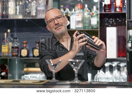 Portrait Elderly Bartender Man With Glasses Holding In Hands A Shaker With A Fresh Delicious Cocktai