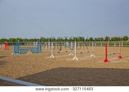 Wooden Barriers For Jumping Horses As A Background. Colorful Photo Of Equestrian Obstacles. Empty Fi