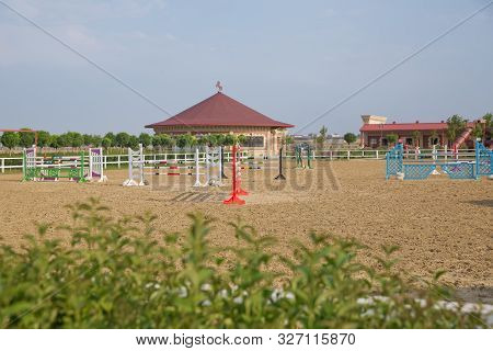 Wooden Barriers For Jumping Horses As A Background. Colorful Photo Of Equestrian Obstacles. Empty Fi