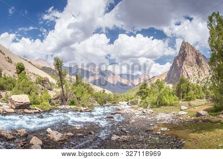 Summer Mountains Landscape. Mountain River In Valley In Tajikistan. Beautiful View On Scenery Rocks 