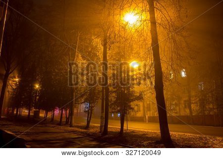 Dimly Illuminated City Street At Night During A Thick Fog, Foggy Evening