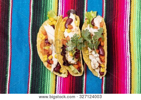 Closeup Of Three Tacos On Colorful Cloth