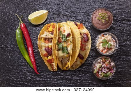 Overview Of Three Mexican Tacos On Black Slate