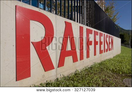 Cadro, Ticino, Switzerland - 7th October 2019 : Logo Of The Swiss Raiffeisen Bank Hanging In Front O