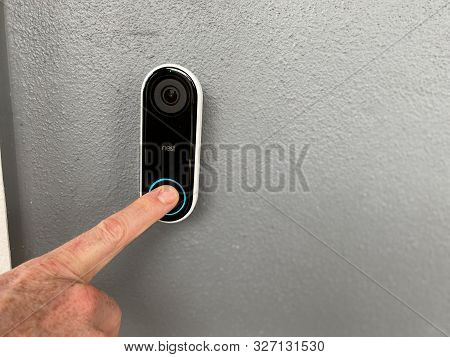 Orlando,fl/usa-10/10/19: A Person Pressing A Ring Doorbell That Has A Motion Sensor Camera And Is A 