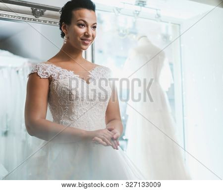 Beautifu bride choosing wedding dress in a wedding salon