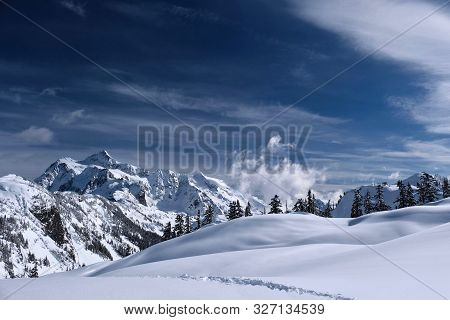 Snowy Landscape With Mountains, Hills And Trees Covered With  Fresh Snow After Heavy Snowfall. Mount