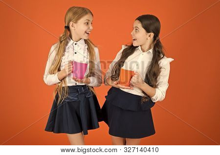 Tea Break. Girls Kids School Uniform Orange Background. Schoolgirl Hold Mug. School Lunch. Having Br