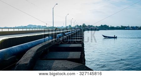 Man On Speed Boat Crossing A Bridge In The Port Of Tumaco, Colombia