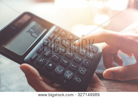 Woman Hand Use Calculator With A Stack Of Bitcoins Coins As Symbol Of Cryptocurrency Digital Money I