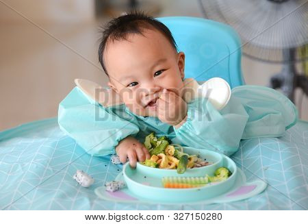 Happy Eating Asian Baby Boy, 7 Months Old Eating With Baby Led Weaning (blw) Method, Self-feeding