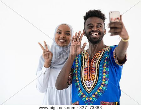 young african muslim business people cople making selfie photo with smartphone isolated on white background in studio happy students group taking self portrait