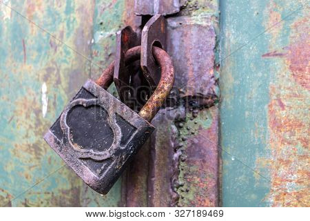 Old And Rusty Padlock With Scratches Locks The Steel Doors Of An Abandoned Vault