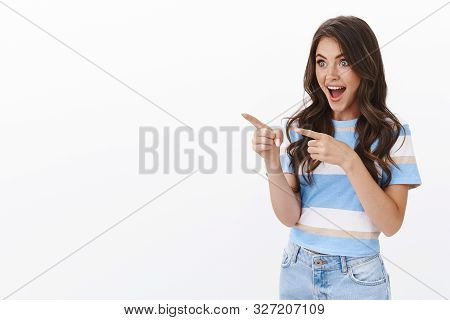 Amazed Cheerful Thrilled Woman Fan, Staring With Admiration And Joy, Pointing Fingers Left Drop Jaw 