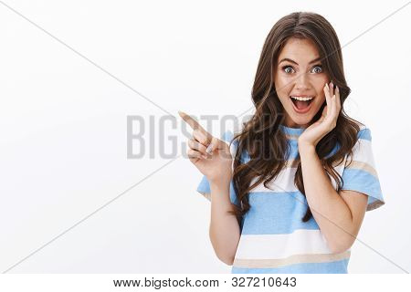 Enthusiastic Joyful Surprised Woman Introduce Incredible Offer, Pointing Finger Left Copy Space, Smi