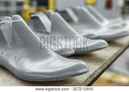 Plastic Lasts Used In The Manufacture Of Shoes. Row Of Plastic Shoe Lasts Used To Manufacture Modern