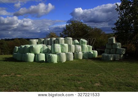 Hay Bales That Are Packed With Foil Store In A Meadow