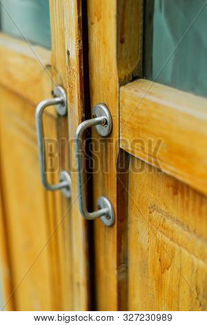 Metal Handle On A Brown Wooden Door. Black Wicker Handle On The Old Door. Metal Handle On A Brown Wo