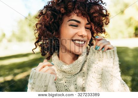 Close-up Portrait Of Beautiful Young Woman Smiling Broadly With Toothy Smile, Posing Against Nature 