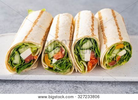 Wrap Sandwich, Roll With Fish Salmon, Vegetables And Cheese. Grey Background. Close Up.