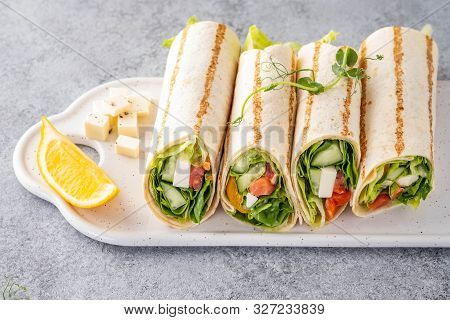 Wrap Sandwich, Roll With Fish Salmon, Vegetables And Cheese. Grey Background. Close Up.